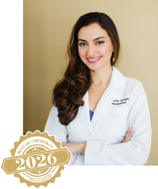 A Portrait Of Dr Giselle In Front Of A Tan Wall Jpg